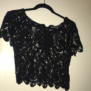 Lace embroidered crop top in black.